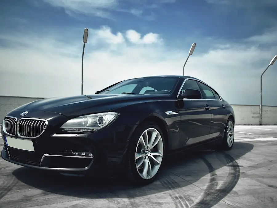 Black business coupé in a car park under a blue sky – illustration