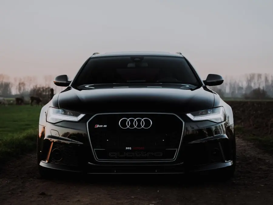 Black premium estate car from the front at sunset – illustration