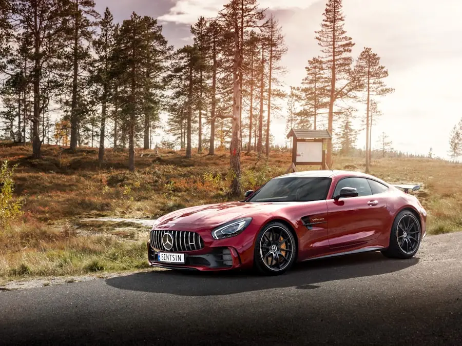 Red sports coupé next to a forest road – illustration